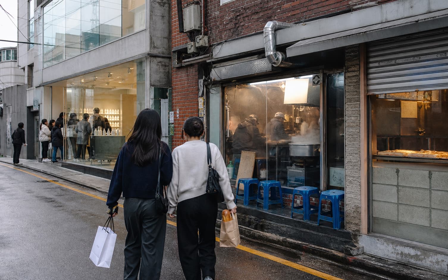 People walking past a small eatery and shop in Seongsu